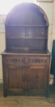A mahogany dresser with curved top and shelves, two drawers over two doors. 178cm x 92cm