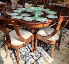 A circular extendable reproduction table and four chairs, table is 112cm with a single centre