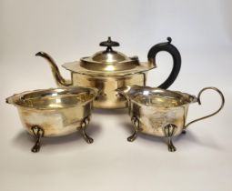 A silver plated tea set, comprising of teapot, milk jug, and sugar bowl, with shaped rim, raised