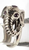 A substantial novelty silver elephant shaped ring, set with red stones.