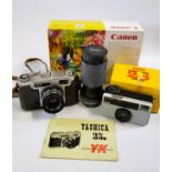 A Yashica 35mm camera, a Vivitar lens and a Kodak Instamatic