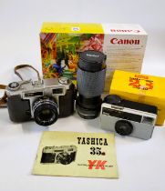 A Yashica 35mm camera, a Vivitar lens and a Kodak Instamatic