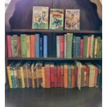 A collection of vintage and antique books, some first editions, including a first edition Biggles