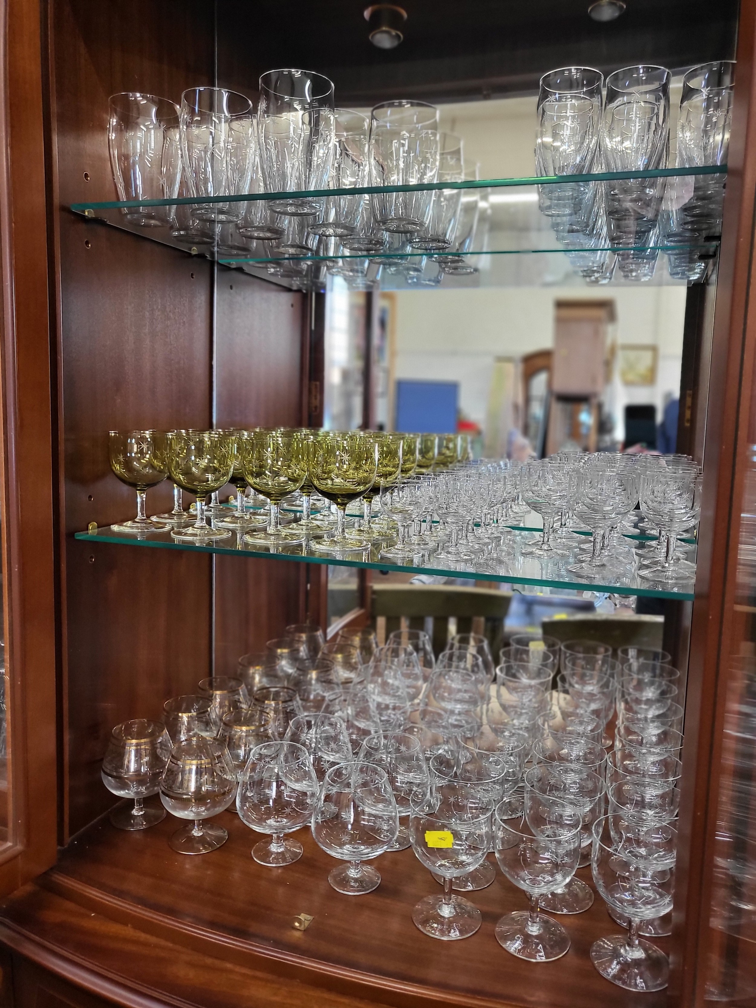 Twelve wine glasses with tinted cup-shaped bowls and sets and part sets of wine glasses and Brandy