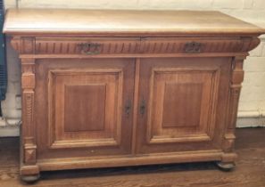 A large blonde oak sideboard, with carved decoration, with key. 93cm x 148cm x 73cm