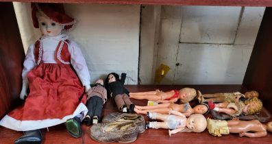 A reproduction bisque doll and eight vinyl and celluloid dolls. (9)