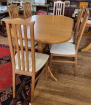 An extending beech table (76cm x 150cm x 91cm) with six matching chairs