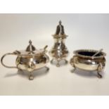 A three piece silver plated condiment set, with gadrooned rims, comprising of mustard pot, salt, and