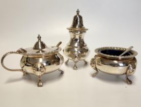 A three piece silver plated condiment set, with gadrooned rims, comprising of mustard pot, salt, and