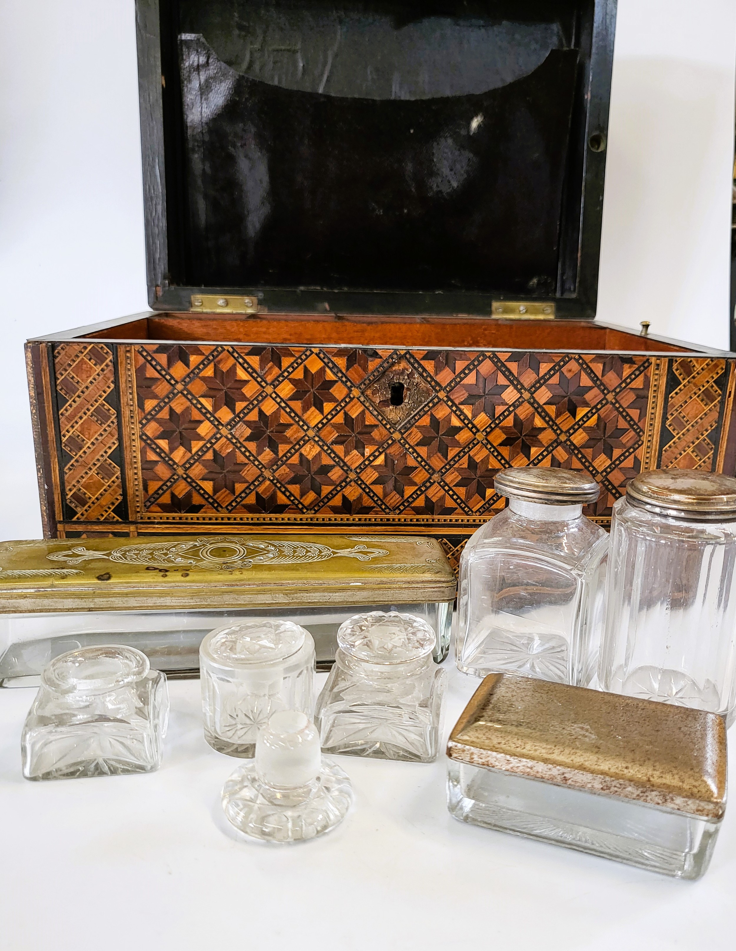 An inlaid wooden box, together with a group of glass bottles.