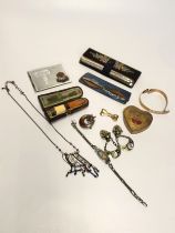 A small group of miscellaneous items, including a yellow metal brooch, a Scottish moon and star