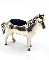 A silver horse pin cushion. Approx 4cm 4cm.