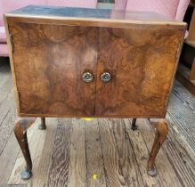 A burr walnut veneer LP cabinet on cabriole legs 71cm x 60cm x 38cm.