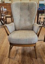 An Ercol 'Greensleeves' high back chair with a curved Windsor back.