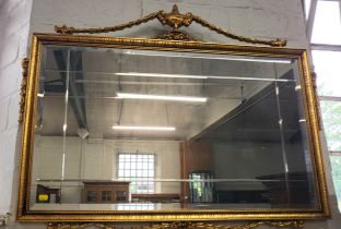A mirror in decorative gilt frame