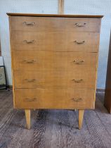 A mid-century chest of five drawers on legs 107cm x 78cm x 43cm.