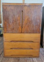 A mid-century TV cabinet with two doors over three drawers 112cm x 76cm x 45cm.