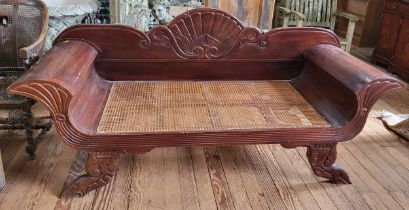 A William IV window seat, with carved back and legs, rattan seat. 90cm x 200cm x 68cm