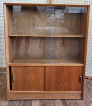 A mid-century cabinet with glass sliding doors and shelf by Herbert E Gibbs. 112cm x 92cm x 28cm.