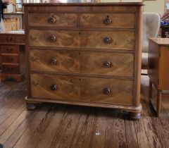 A walnut two short drawers over three long drawers chest of drawers on bun feet. 116cm x 123cm x
