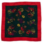 A Givenchy silk scarf with rose print design In Christmas colours of green and red along with