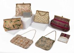 A collection of embroidered and beaded evening purses to include a magenta clutch with matching