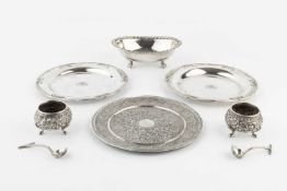 A pair of late 19th/early 20th century Indian silver salts, relief decorated with scrolling foliage,