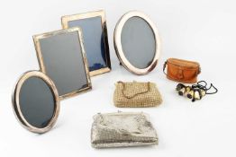 A silver oval photograph frame, Sheffield 1990, 22cm high overall, a similar slightly smaller silver