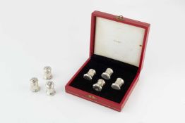 A set of four sterling silver peppers by Cartier, of faceted design, each marked to the base '