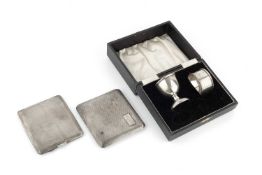 Two silver cigarette cases, with engine turned decoration, London 1927 and Chester 1935, together