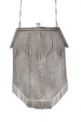 A silver chain link evening purse, the angular snap top clasp decorated with repeated stylised