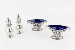 A pair of late Victorian silver twin handled pedestal salts, of neo-classical pierce-decorated form,