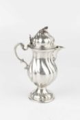 A 19th century Continental silver cream jug, of spirally lobed baluster form with hinged cover,
