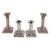 A pair of Edwardian silver candlesticks, with reeded columns, corinthian capitals and gadrooned
