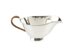 A 20th century Danish silver sauce boat, of plain oval form, with wicker covered handle, assayer's