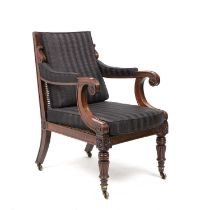 A William IV mahogany framed bergere armchair with scrolling arms reeded legs and brass castors 62cm