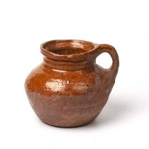 A 16th/17th century Pottery jar 18cm wide 16cm high areas of restoration