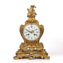 A late 19th/early 20th century French gilt metal mantel timepiece with acanthus scrolls the