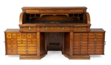 A 19th century continental mahogany roll top pivoting doctors apothecary desk in the manner of