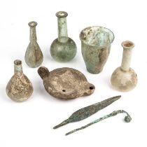 Five pieces of Roman glass to include a beaker, 7.5cm wide x 10cm high, together with a Roman oil