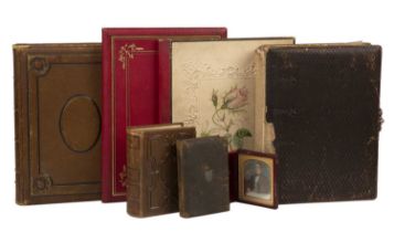 Four late 19th/ early 20th century photograph albums to include photographs, the largest 30cm x
