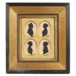 An early Victorian family group of four silhouettes all mounted in a gilded frame overall 39cm x