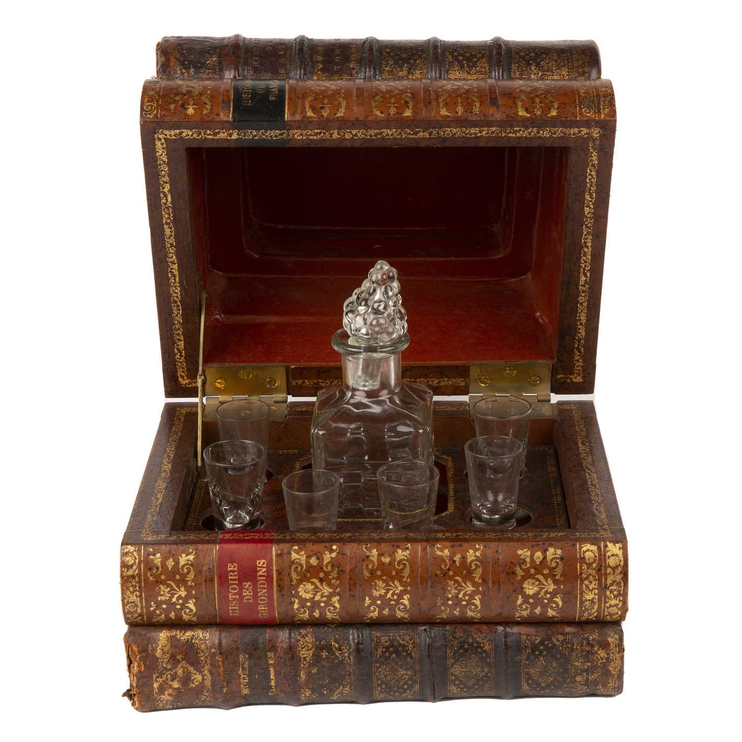 An early 20th century French leather bound Tantalus in the form of a stack of books, with later