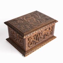 A late 19th century carved oak box with carved Celtic dragon decoration and interior tray 33cm