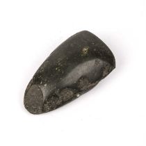 An antique carved stone axe head 6cm x 11.5cm Provenance: Malcolm Deas Collection