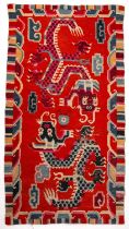 An antique Tibetan dragon rug with red blue and pink dyes 87cm x 165cm