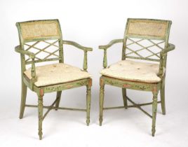 A pair of 19th century Regency style painted elbow chairs with cane seats and turned legs united