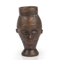 A west African Kuba carved hardwood wine cup 10.5cm wide 19cm high