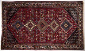 A modern Isfahan red ground rug with five central diamond motifs 150cm x 250cm Small old areas of