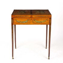 An Edwardian Sheraton revival painted satinwood dressing table with a hinged top square tapering